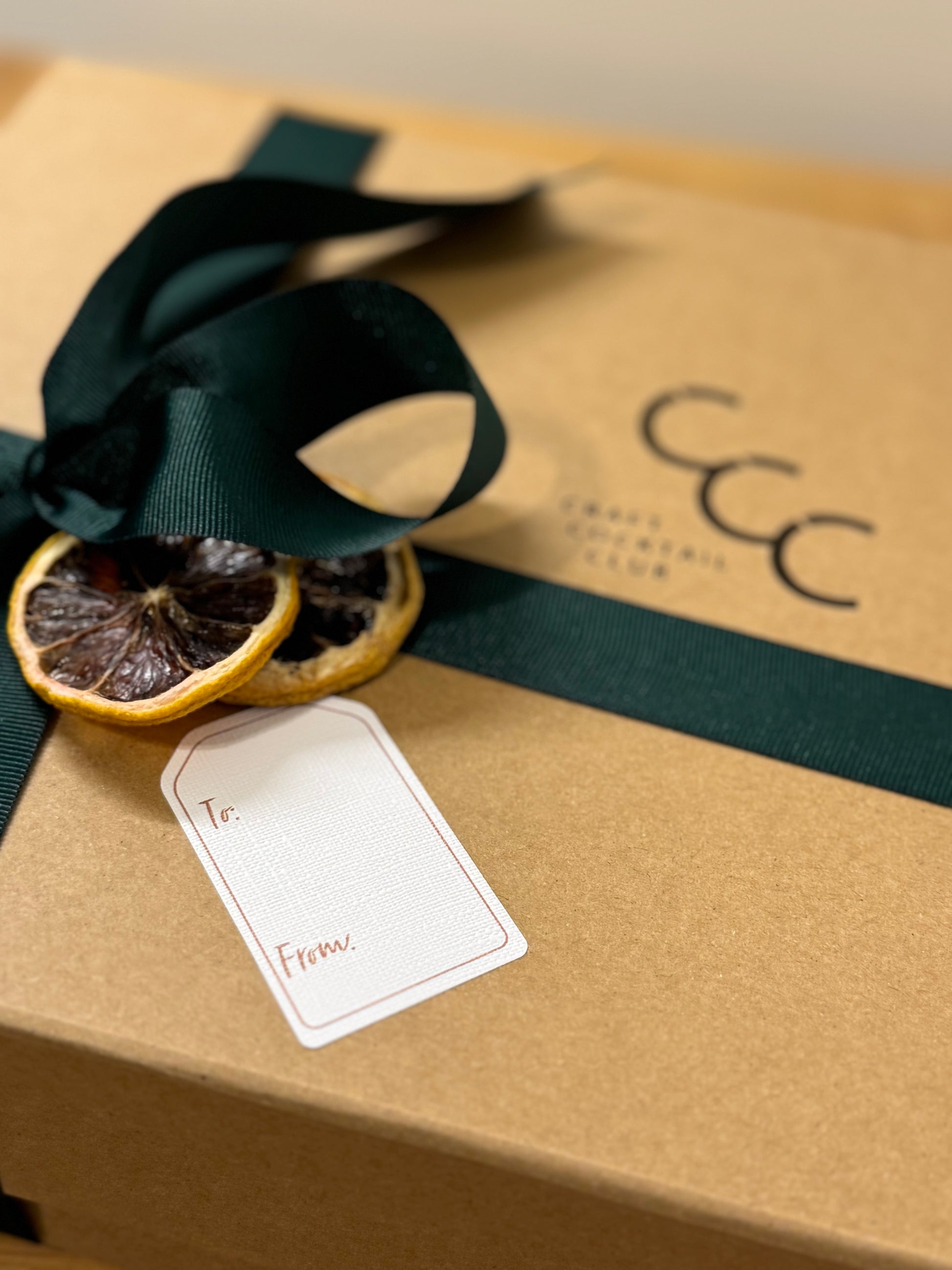 picture of a gift box with dried lemons on to logo says craft cocktail club 