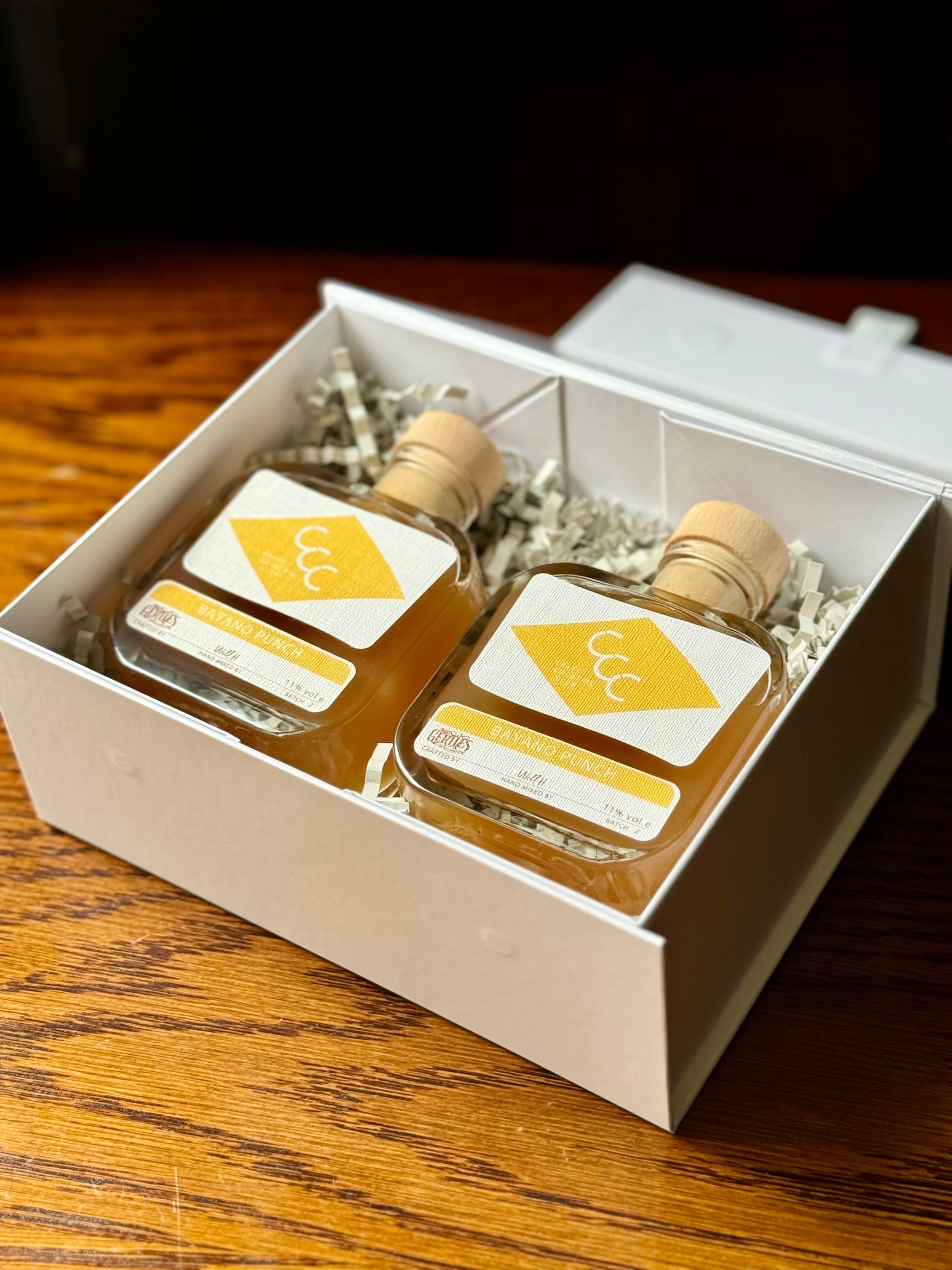 picture of a gift box of Bayano punch bottles in a gift box on a wooden table 