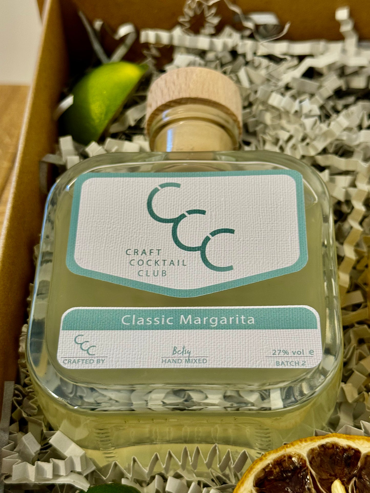 picture of a gift box with a zoomed in look at one green bottle that reads Craft Cocktail Club, Classic Margarita 