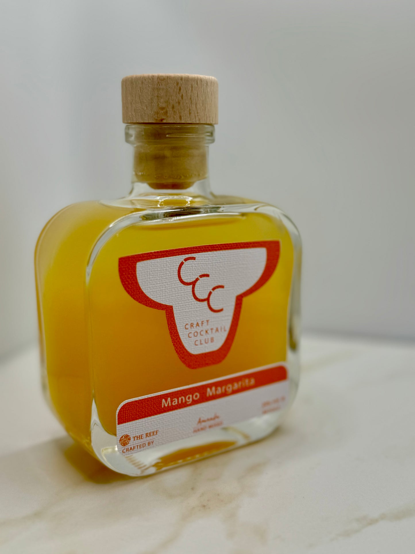 picture of a single bottle with orange content, its a  craft cocktail club margarita bottle 