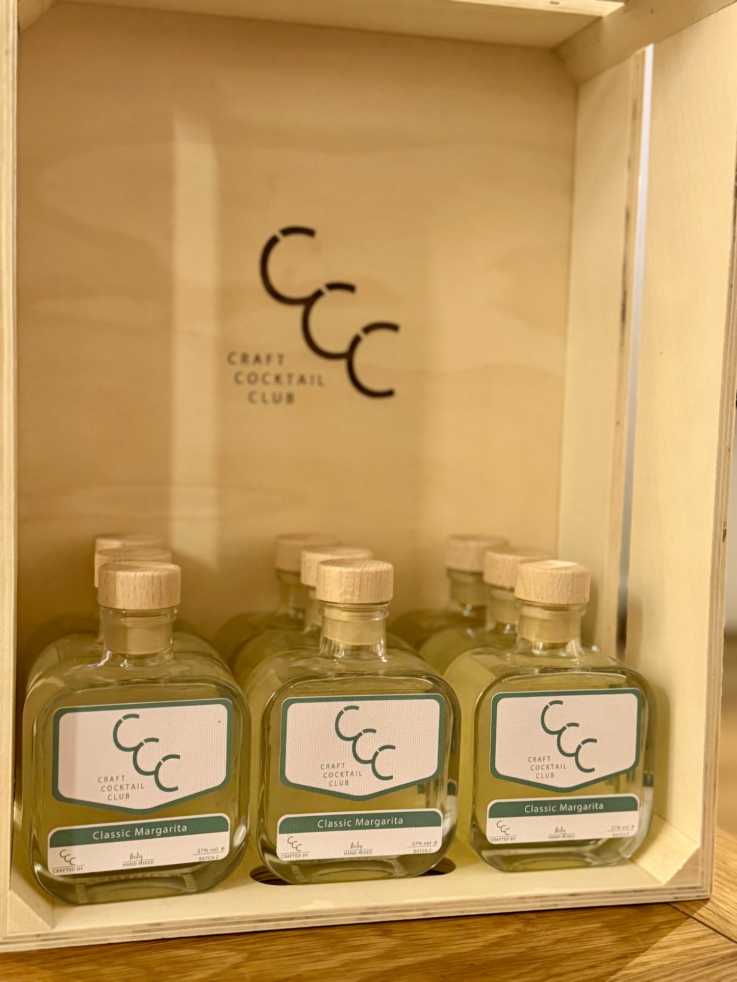 picture of 9 bottles of ready to drink margarita in a wooden box 