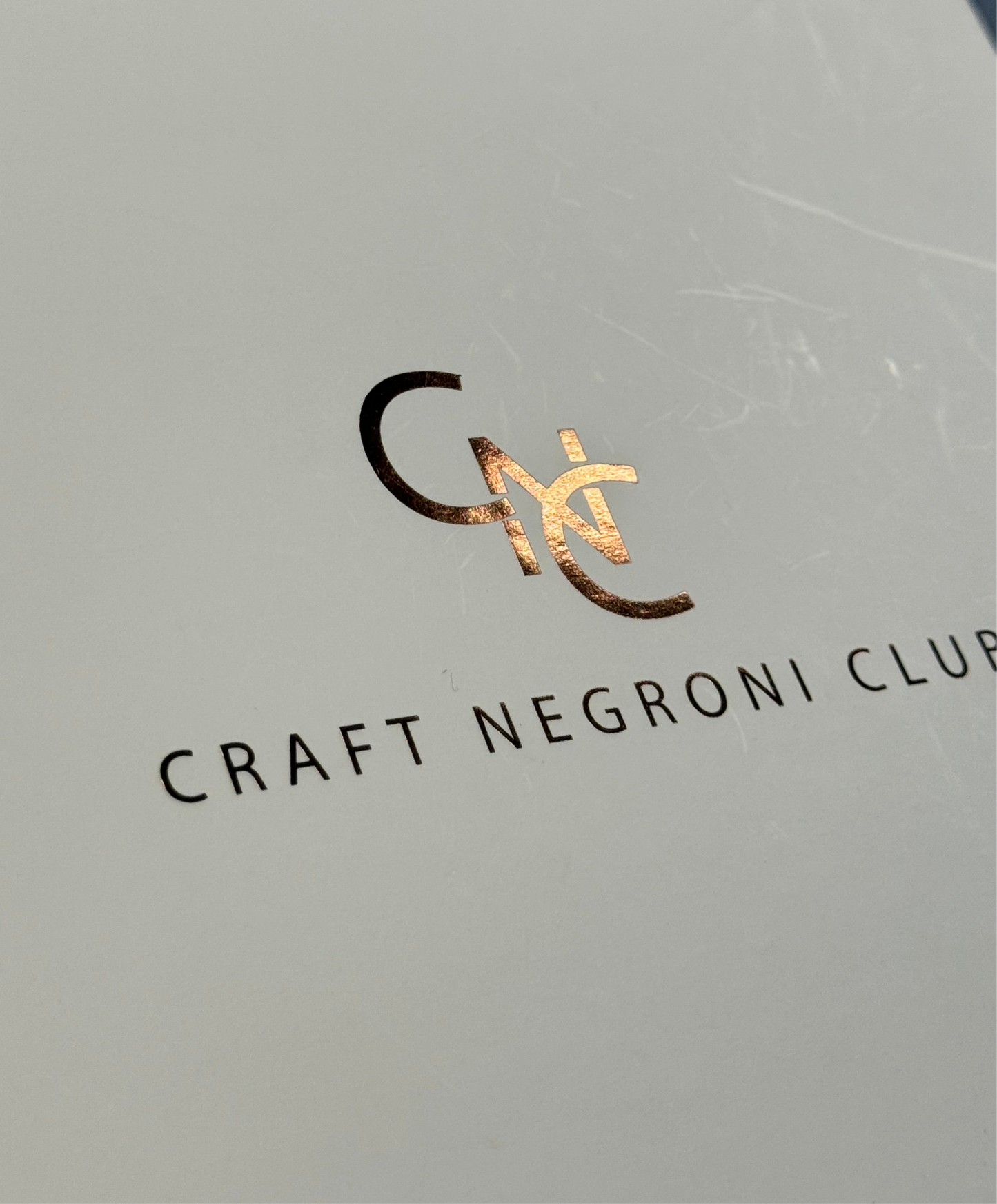 picture of a bronze logo that reads Craft Negroni Club 