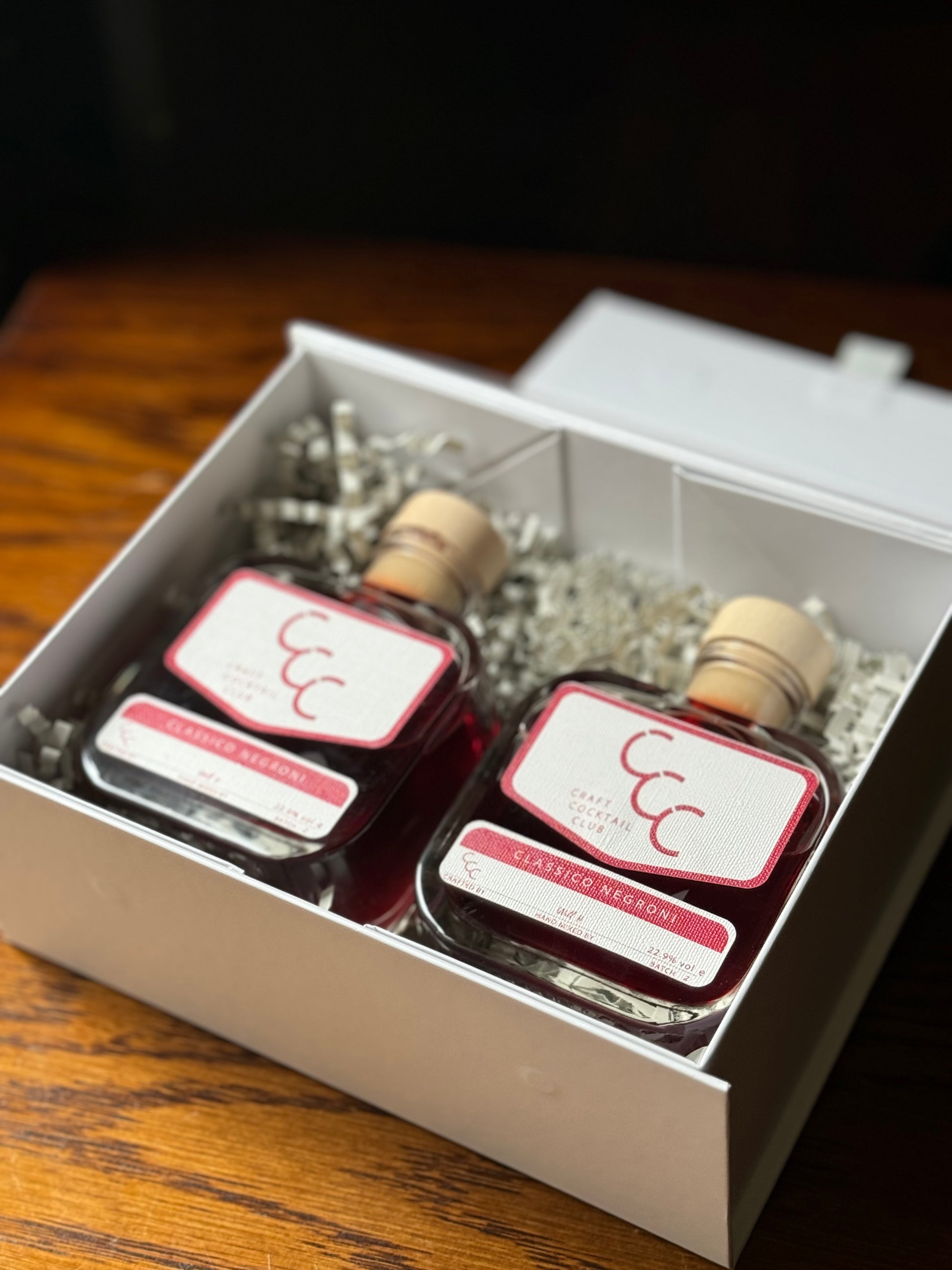 picture of two bottles of negroni in a gift box on a table 