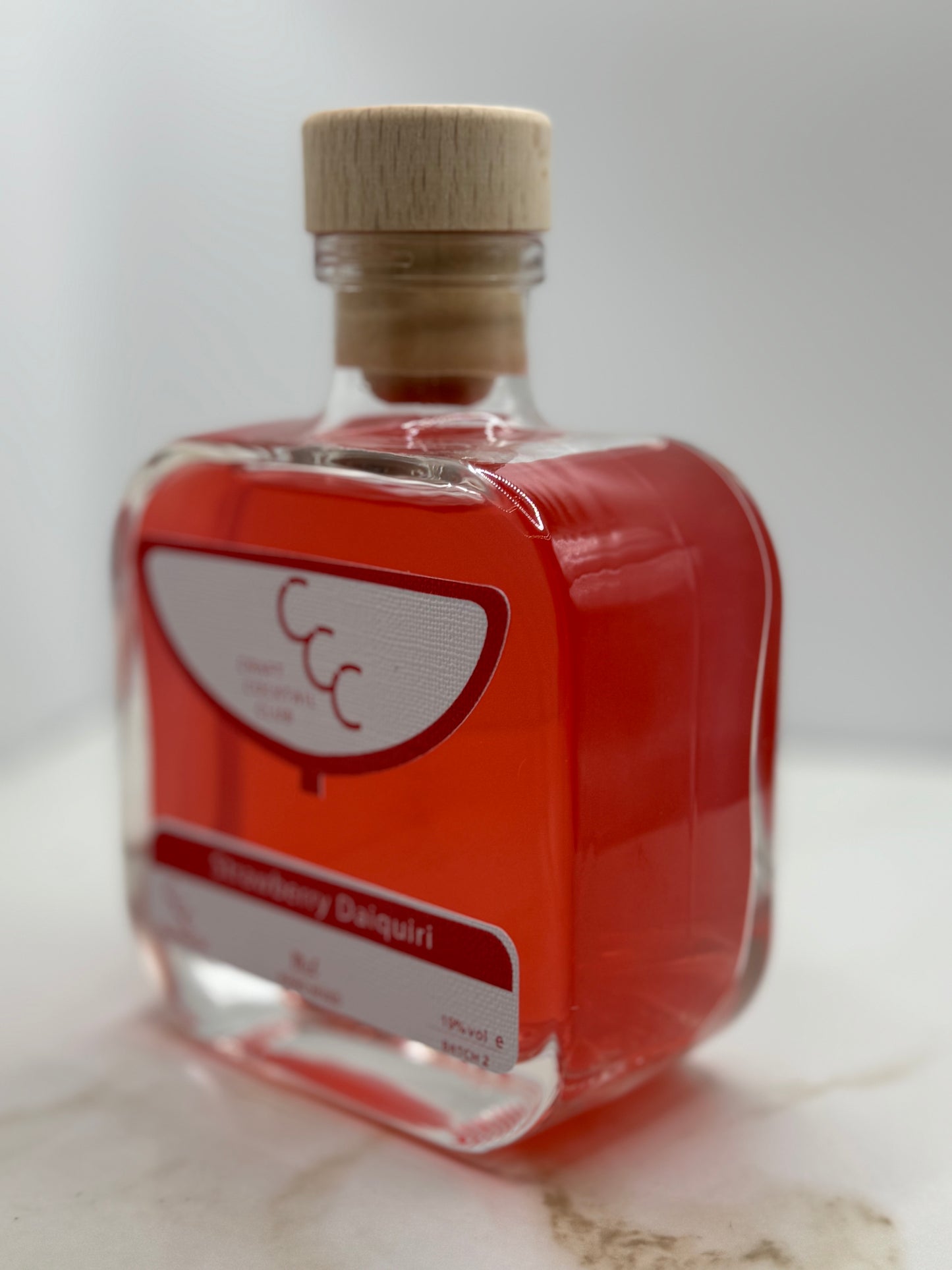 Picture of a single bottle of craft cocktail club cocktail  red liquid 