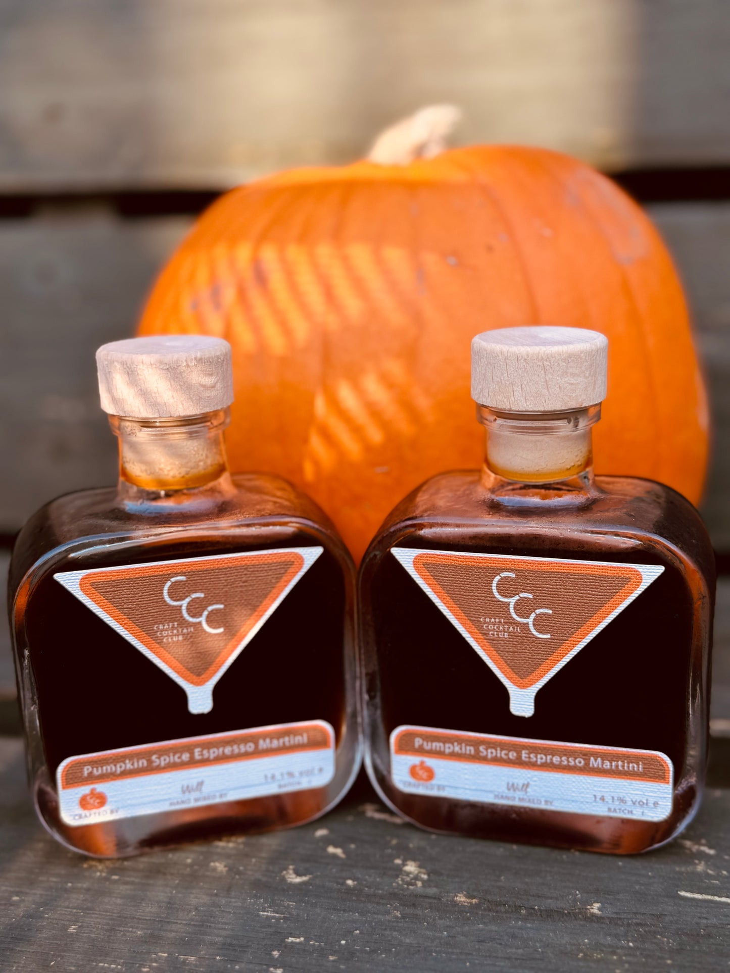 Picture of two bottles of espresso martini together with a pumpkin in the background, label reads craft cocktail club. Pumpkin spice espresso martini 